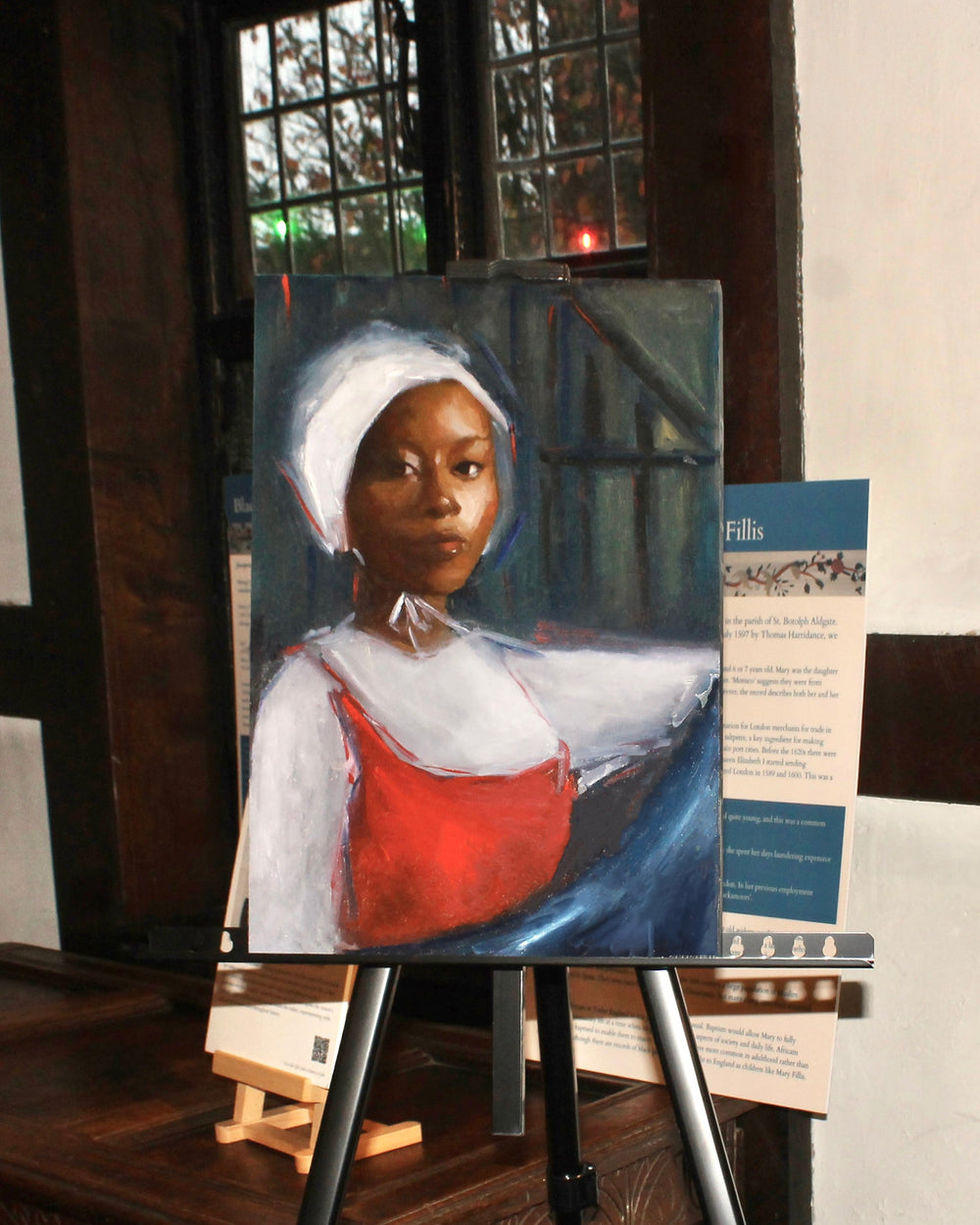 Portrait painting on an easel in a museum setting