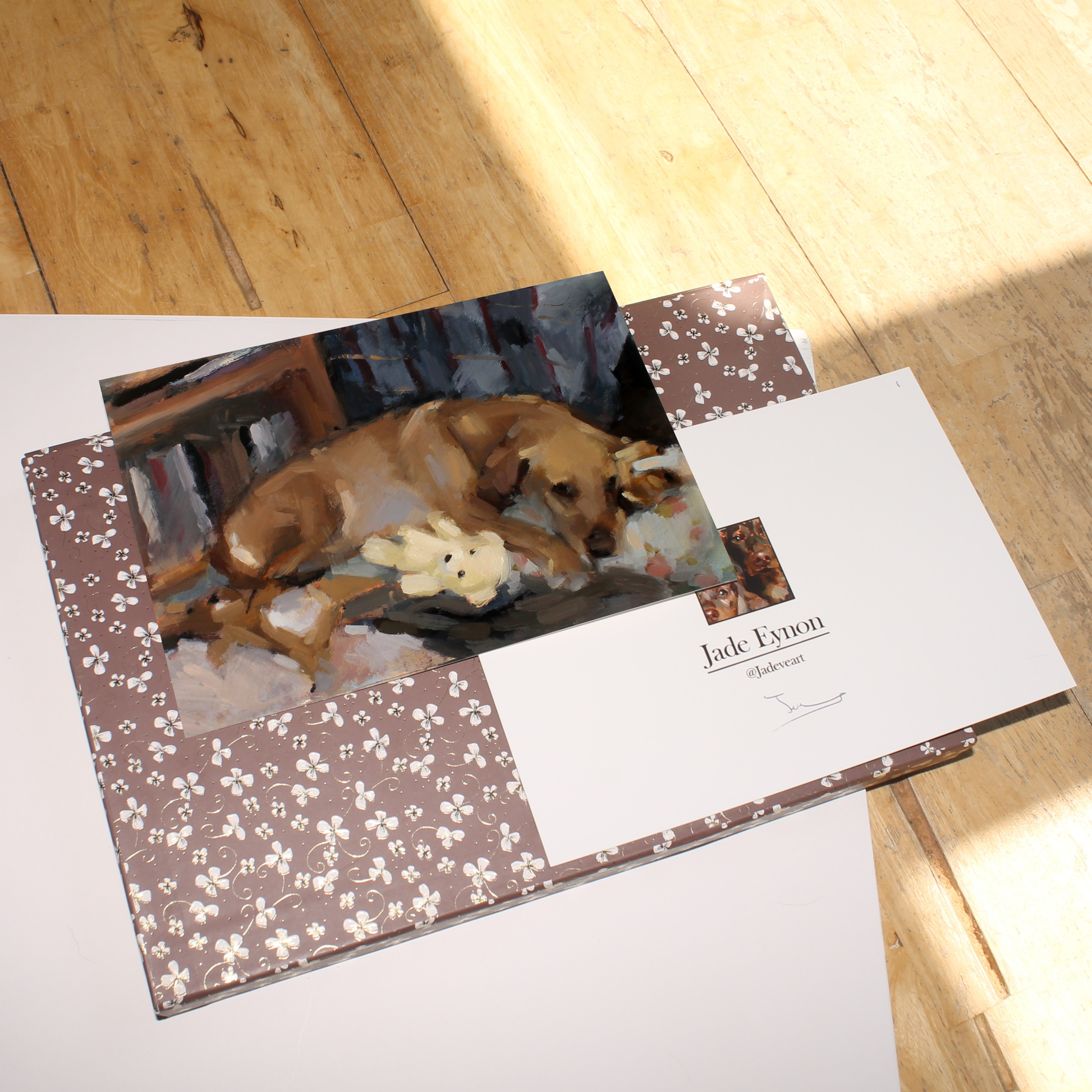 Painting of a Golden Labrador dog sleeping on a floral bed with its teddy bears, in warm neutral colours