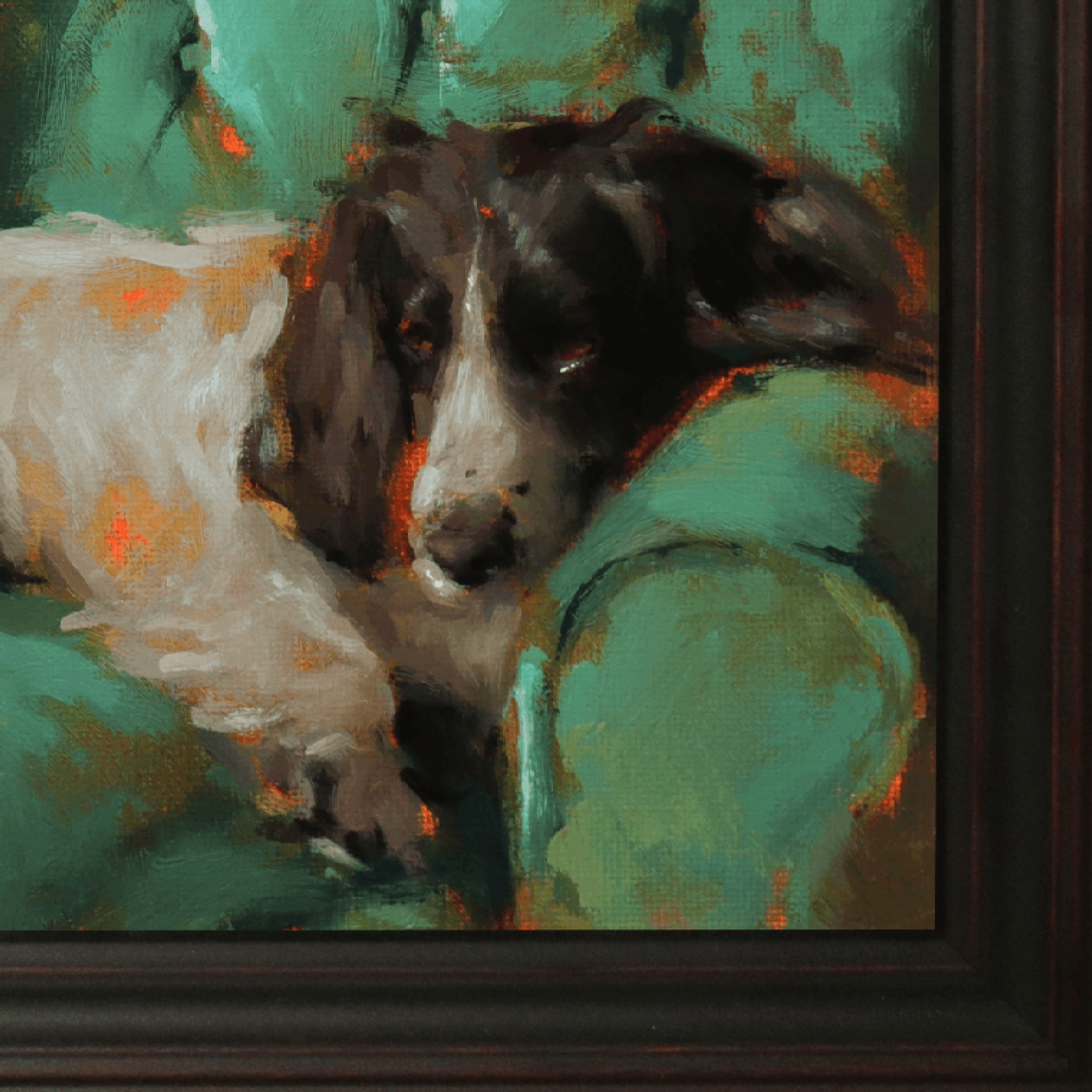 A close-up of a framed painting depicting a black and white dog resting on a green couch, with visible brushstrokes and a dark wood frame.