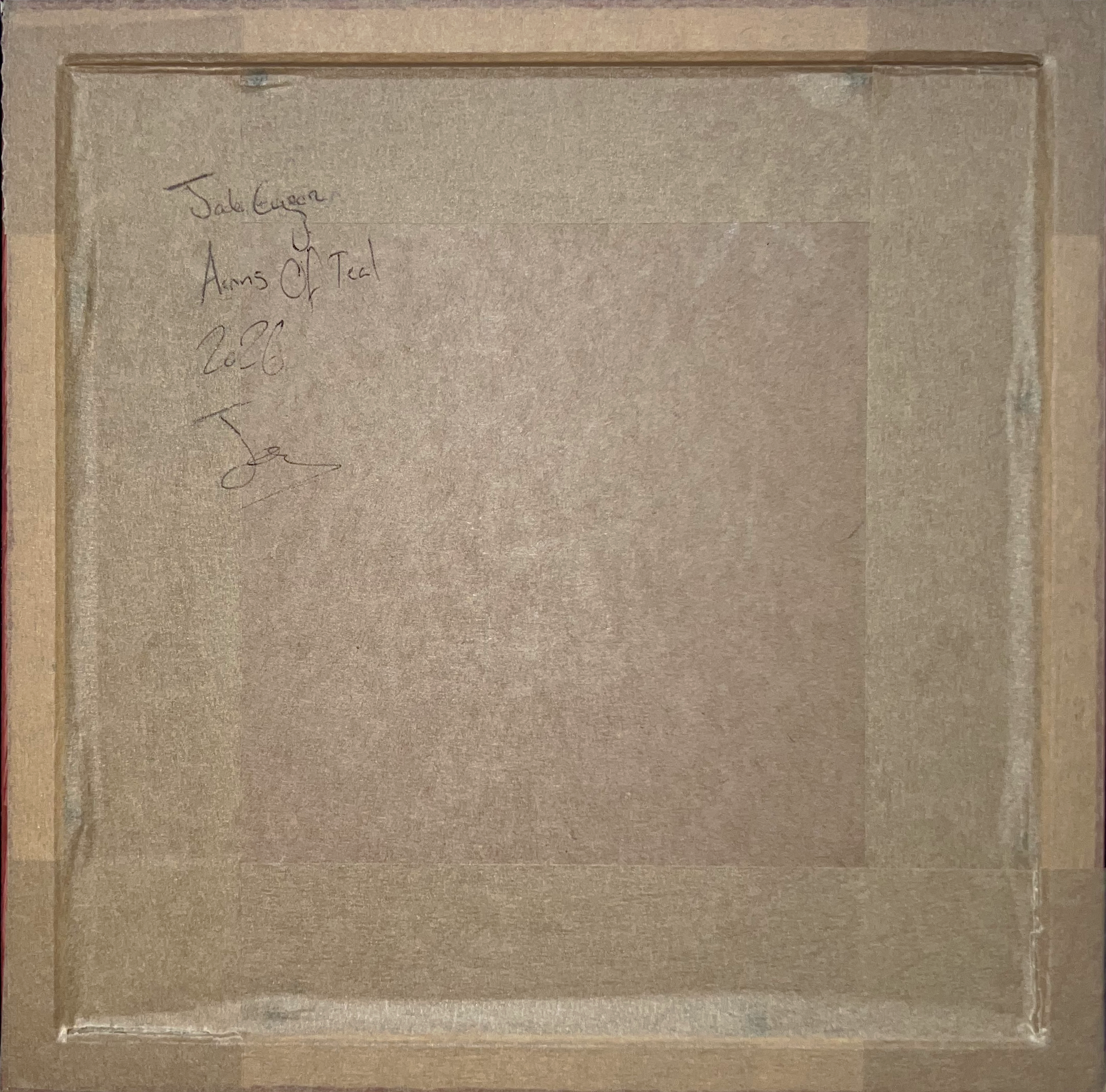 Textured brown paper with handwritten text and a signature on a wooden surface