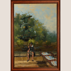 A framed oil painting depicting a seated figure near a table in an outdoor garden setting, enclosed in a warm brown wooden frame against a light beige background.
