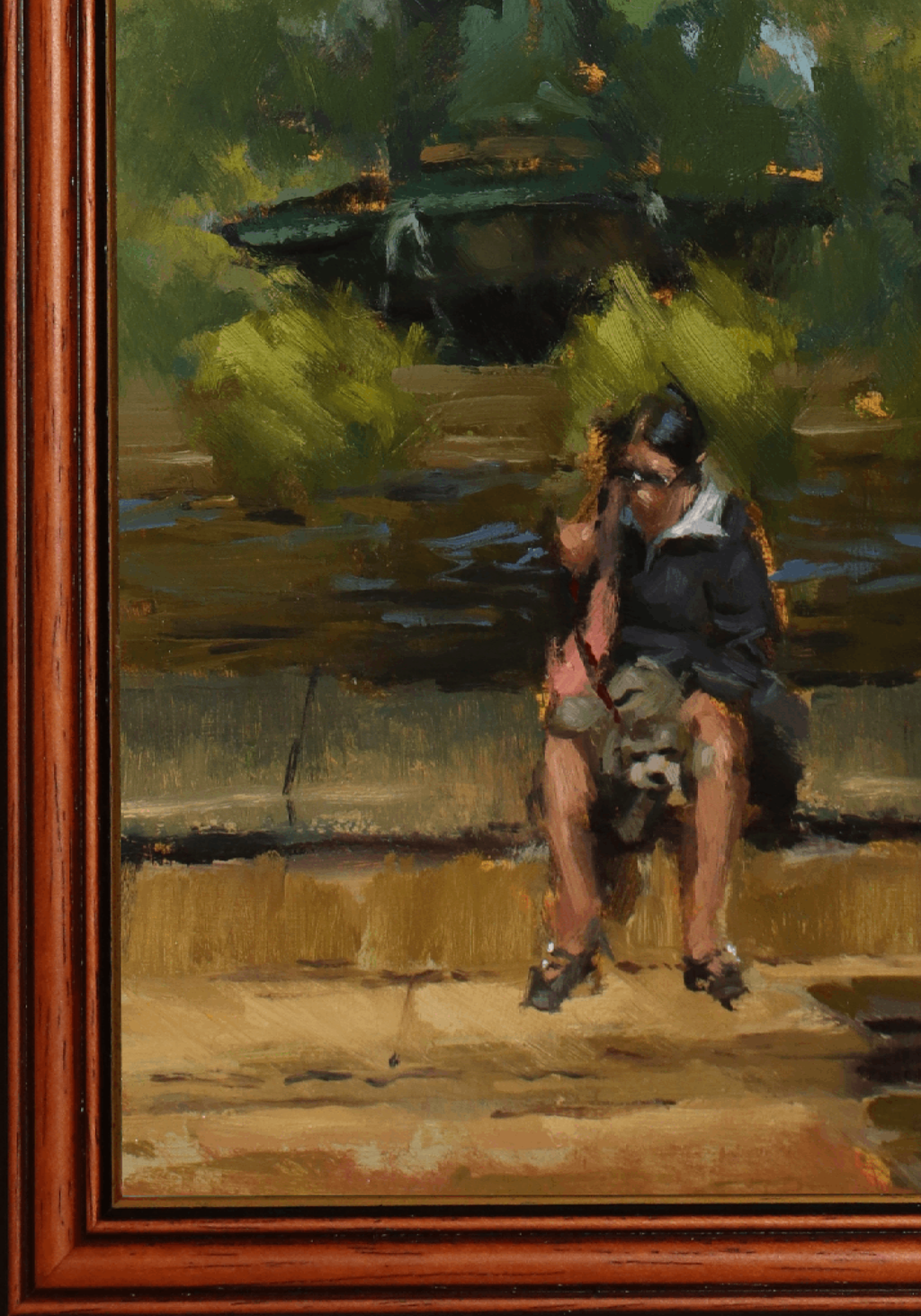 An impressionistic oil painting of a seated woman in a dark dress and sunglasses on a bench, with green foliage and a dark boat in the background, enclosed in a reddish-brown wooden frame.