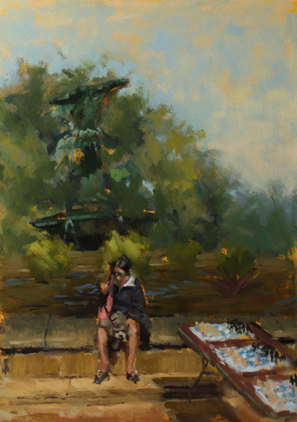 Painting of a person sitting by a lake with trees and a chessboard in the foreground