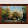 A framed oil painting depicting a street scene with a cyclist, cars, trees, and a building dome under a blue sky, enclosed in a dark brown wooden frame.