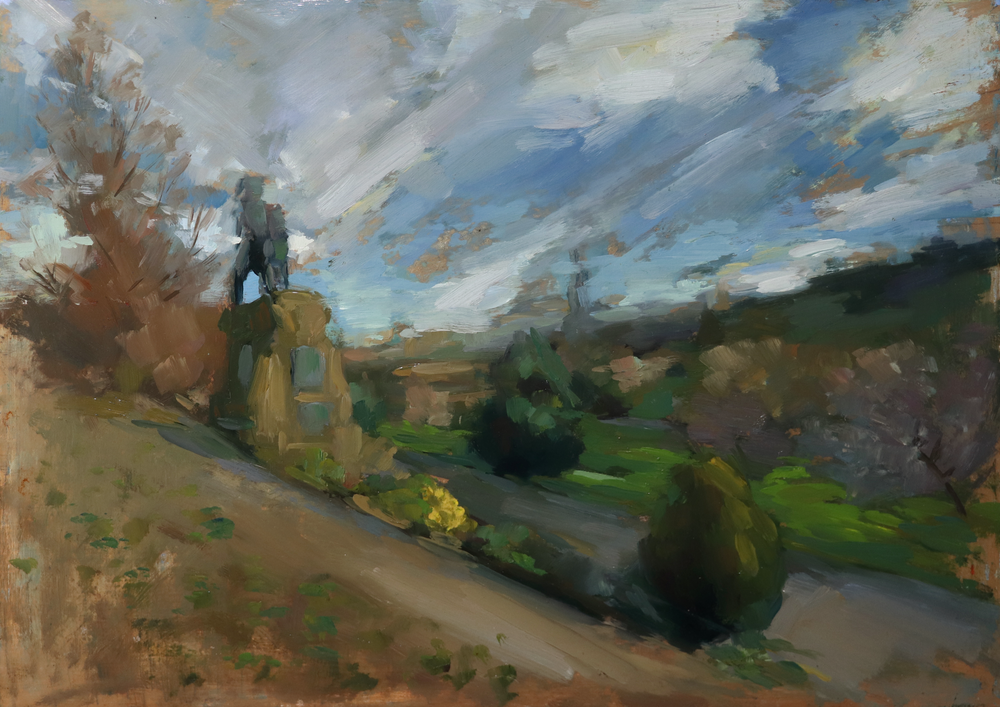 An impressionistic landscape painting depicting a path leading up a hill toward a dark statue atop a stone pedestal, under a dramatic cloudy blue sky with green fields and trees in the background.