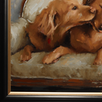 Close-up of a framed painting depicting a golden retriever lying on a cushioned surface, with warm brown and beige tones and a black frame with gold trim.