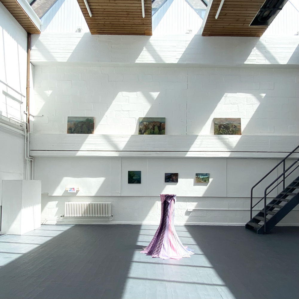 Modern interior with white walls, wooden beams, and a staircase.