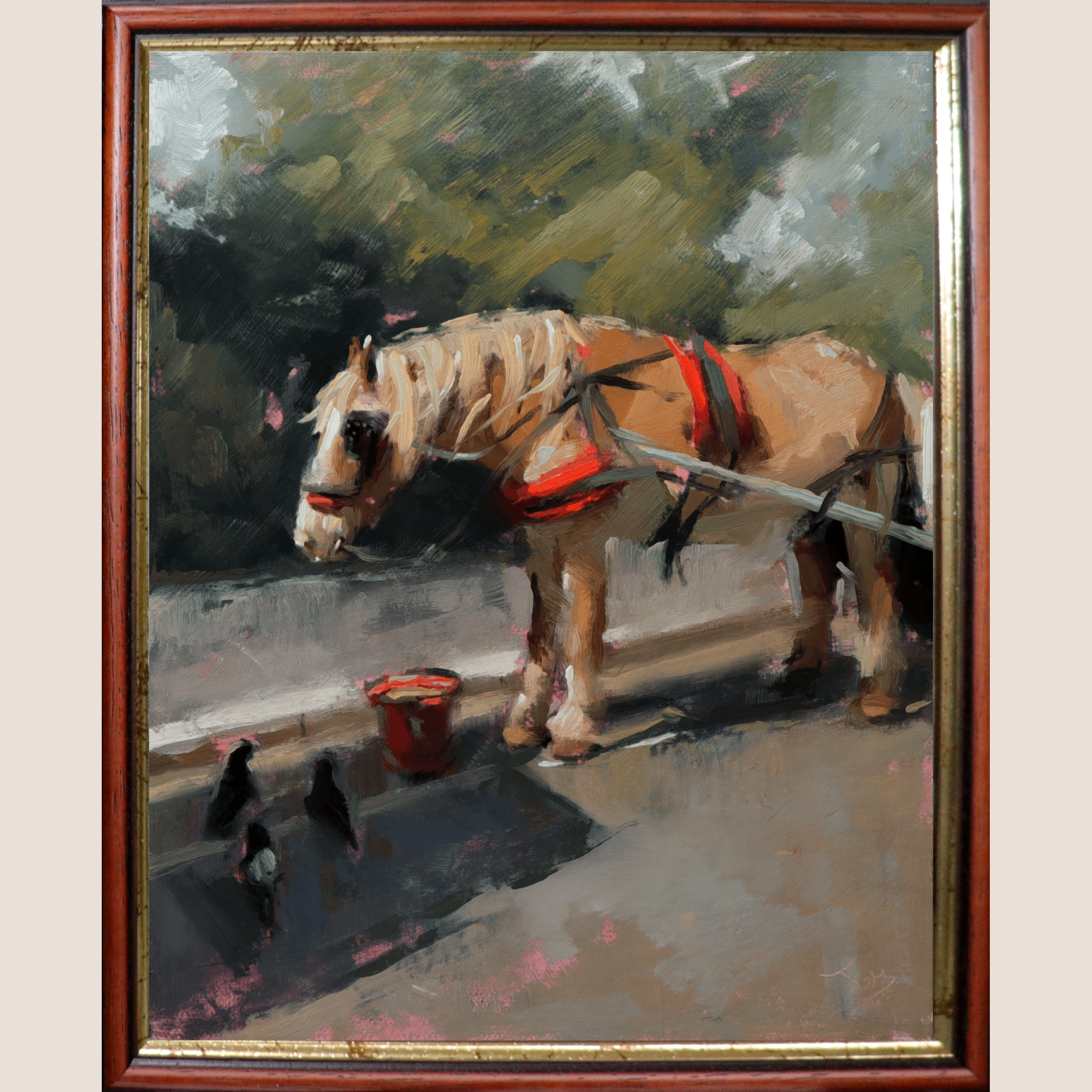 A framed oil painting depicting a light brown horse wearing red harnesses, standing beside a small red bucket on a street with crows in the foreground. The painting is enclosed in a reddish-brown wooden frame with gold-toned inner trim, shown against a light beige background.
