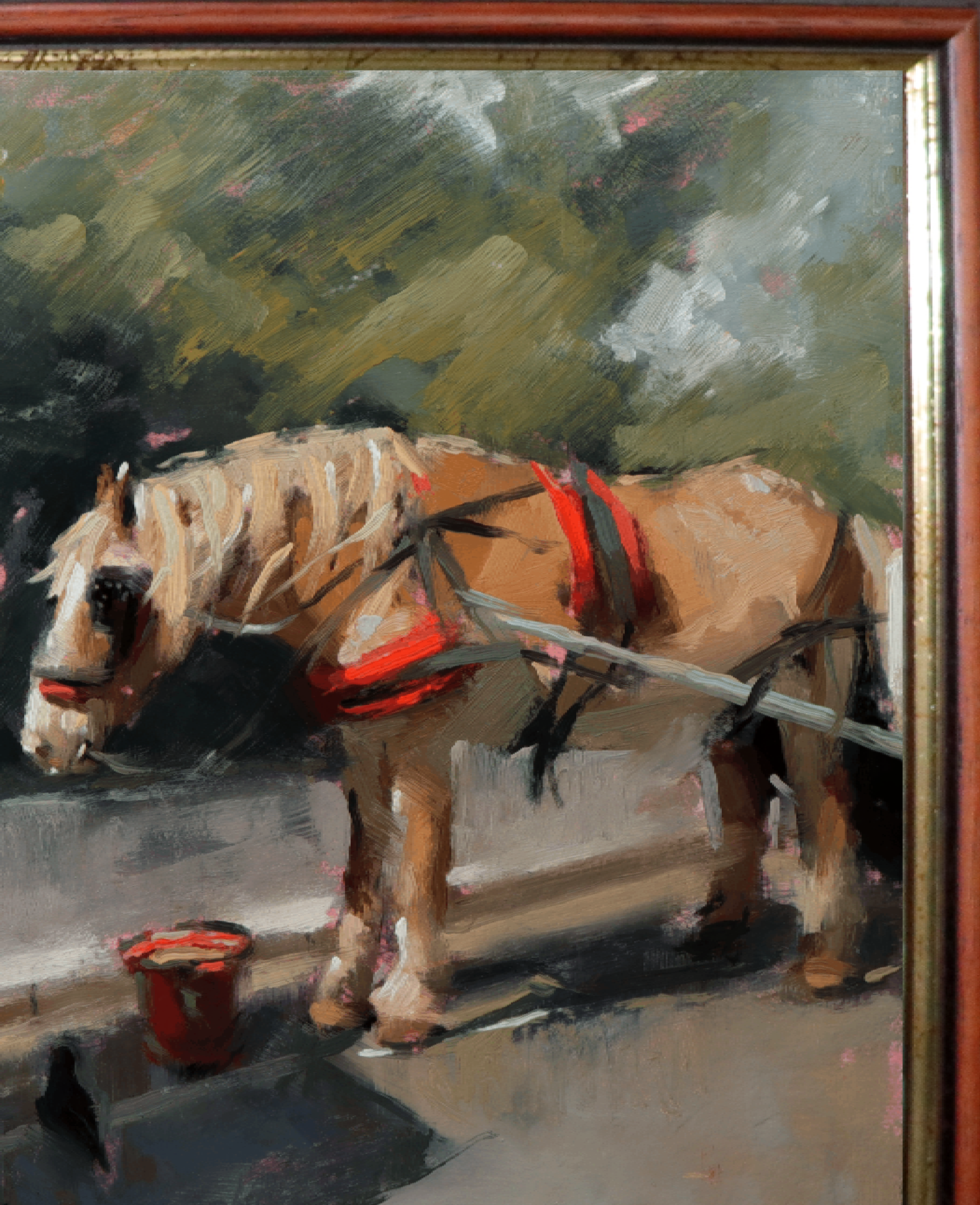 An oil painting of a light brown horse wearing a red harness, standing next to a small red bucket. The painting is housed in a reddish-brown wooden frame with gold trim.
