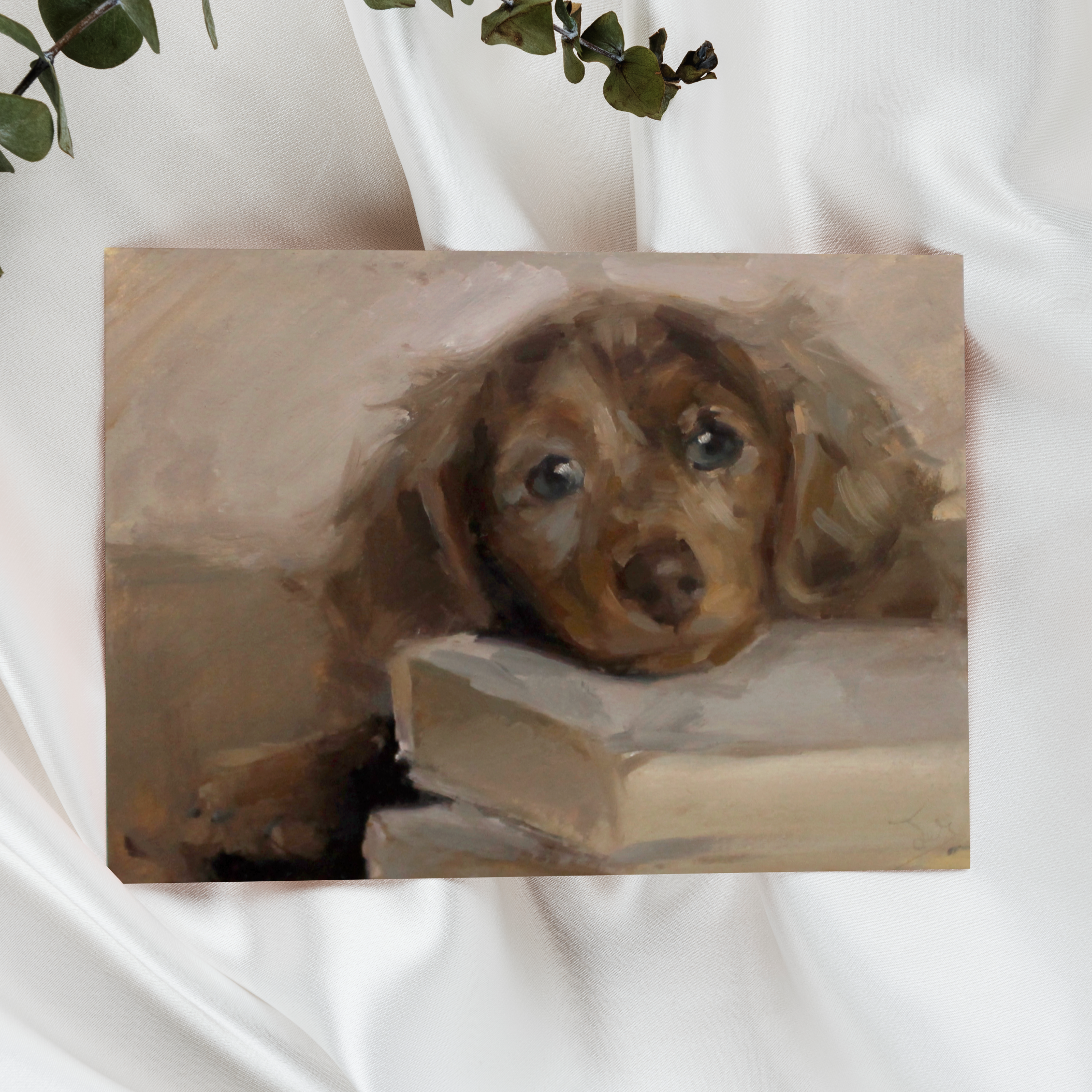 Painting of a dog peeking out from behind a book on a white background