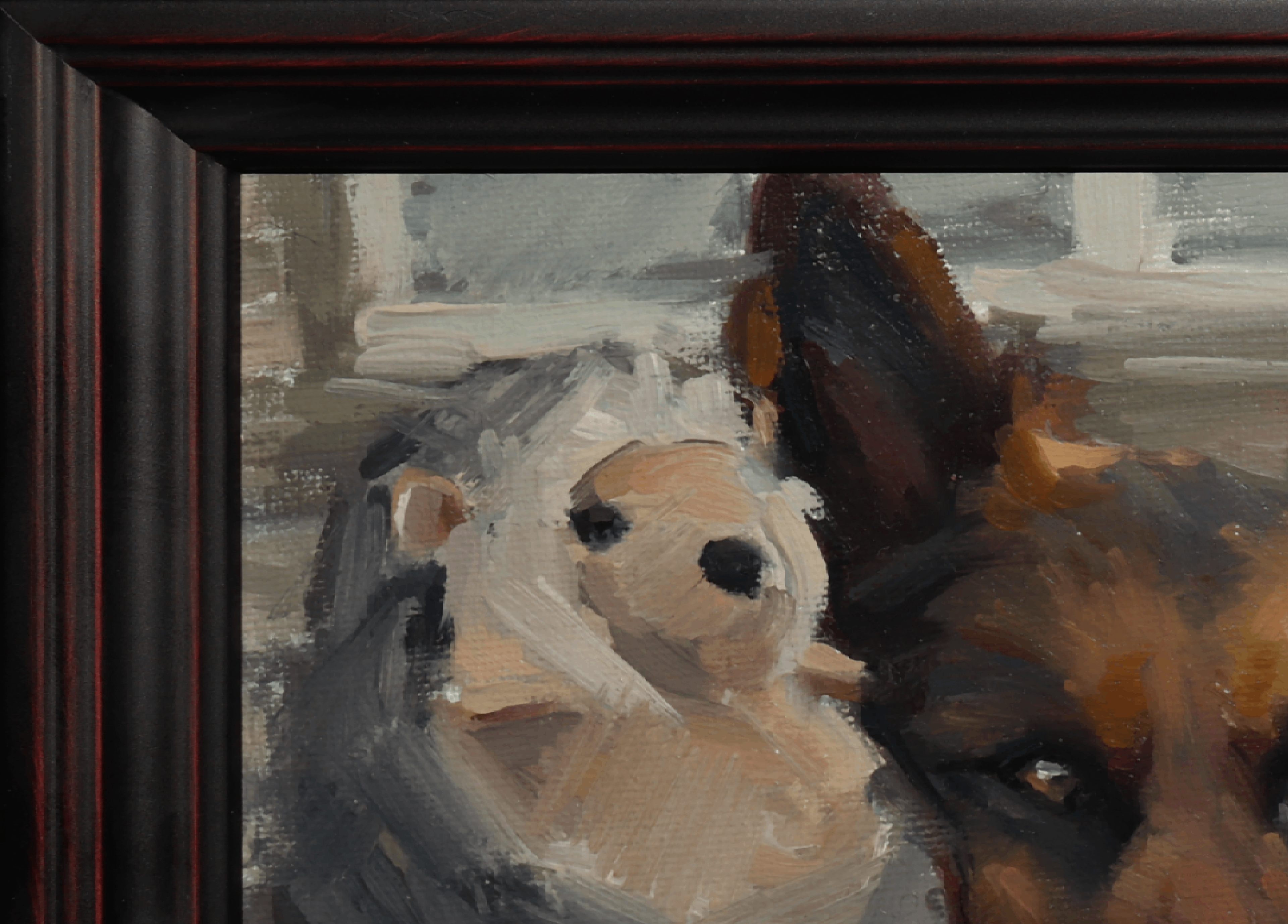 Close-up of a framed painting showing part of a brown dog and a white stuffed animal, with a dark wood frame visible on the left side.