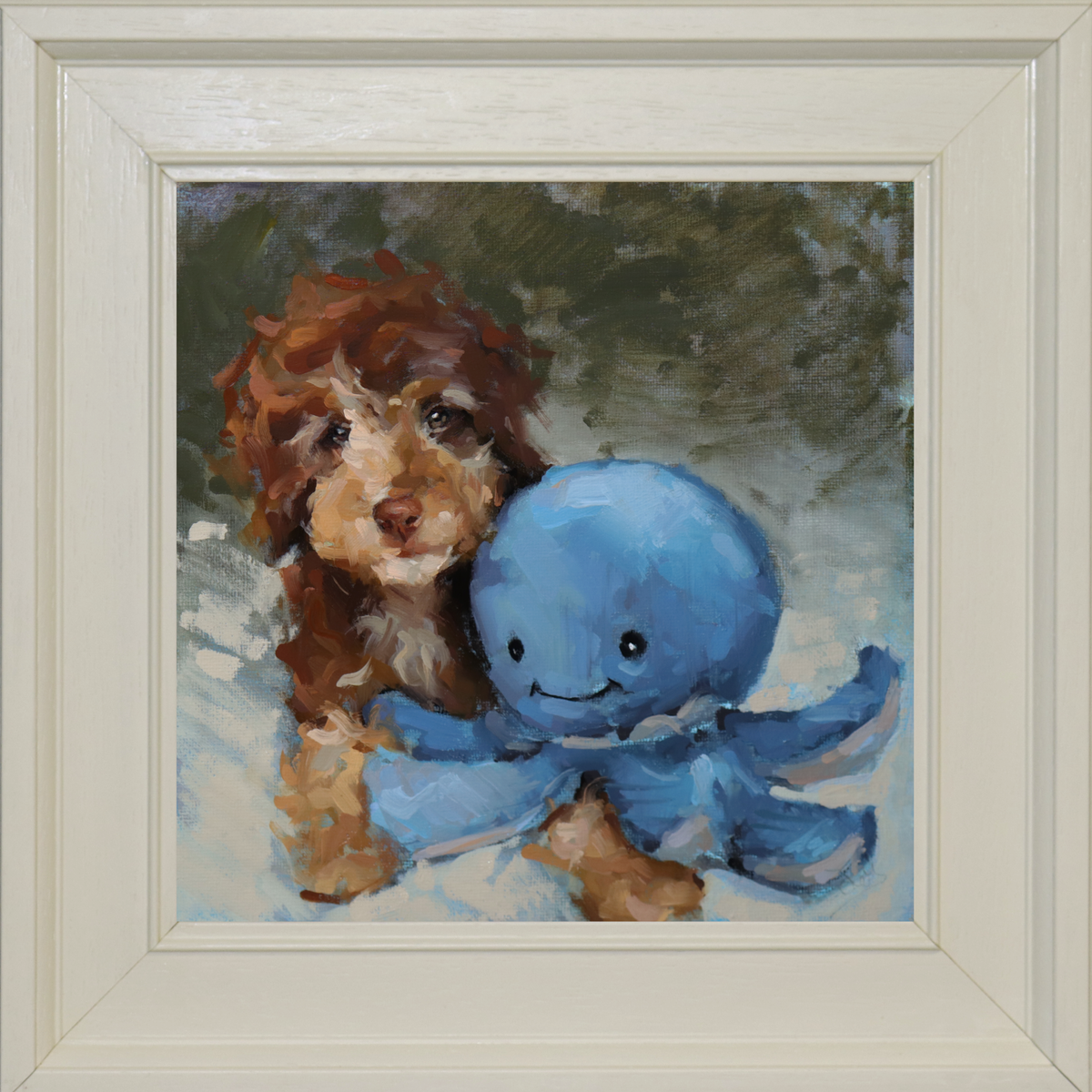 A framed painting featuring a brown and white puppy next to a blue octopus toy, set in a cream-colored square frame.