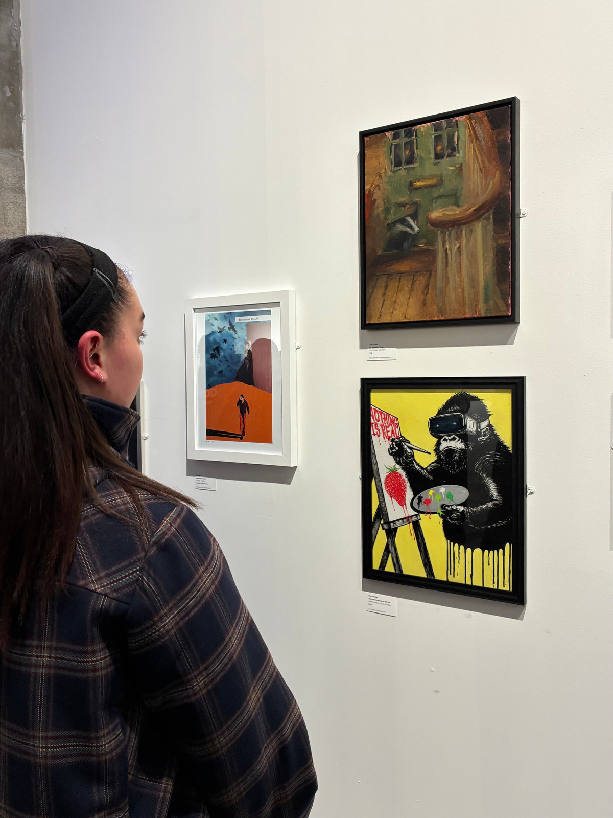 Person looking at artwork on a wall