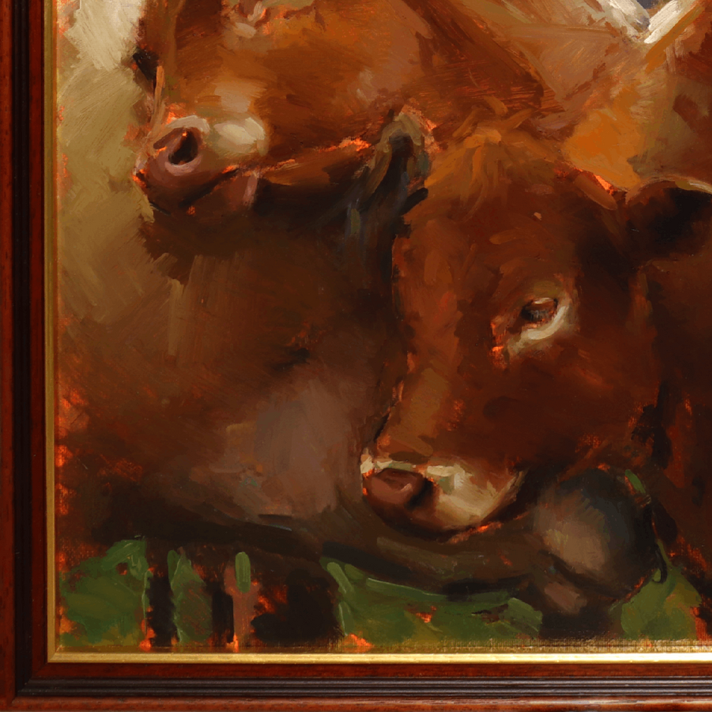 Close-up of an oil painting depicting two brown calves with warm golden and green brushstrokes, framed by a dark wood border with a gold inner edge.