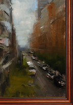 An impressionistic oil painting of a narrow city street flanked by tall brown buildings, with parked cars and a cloudy sky, shown within a warm brown wooden frame.